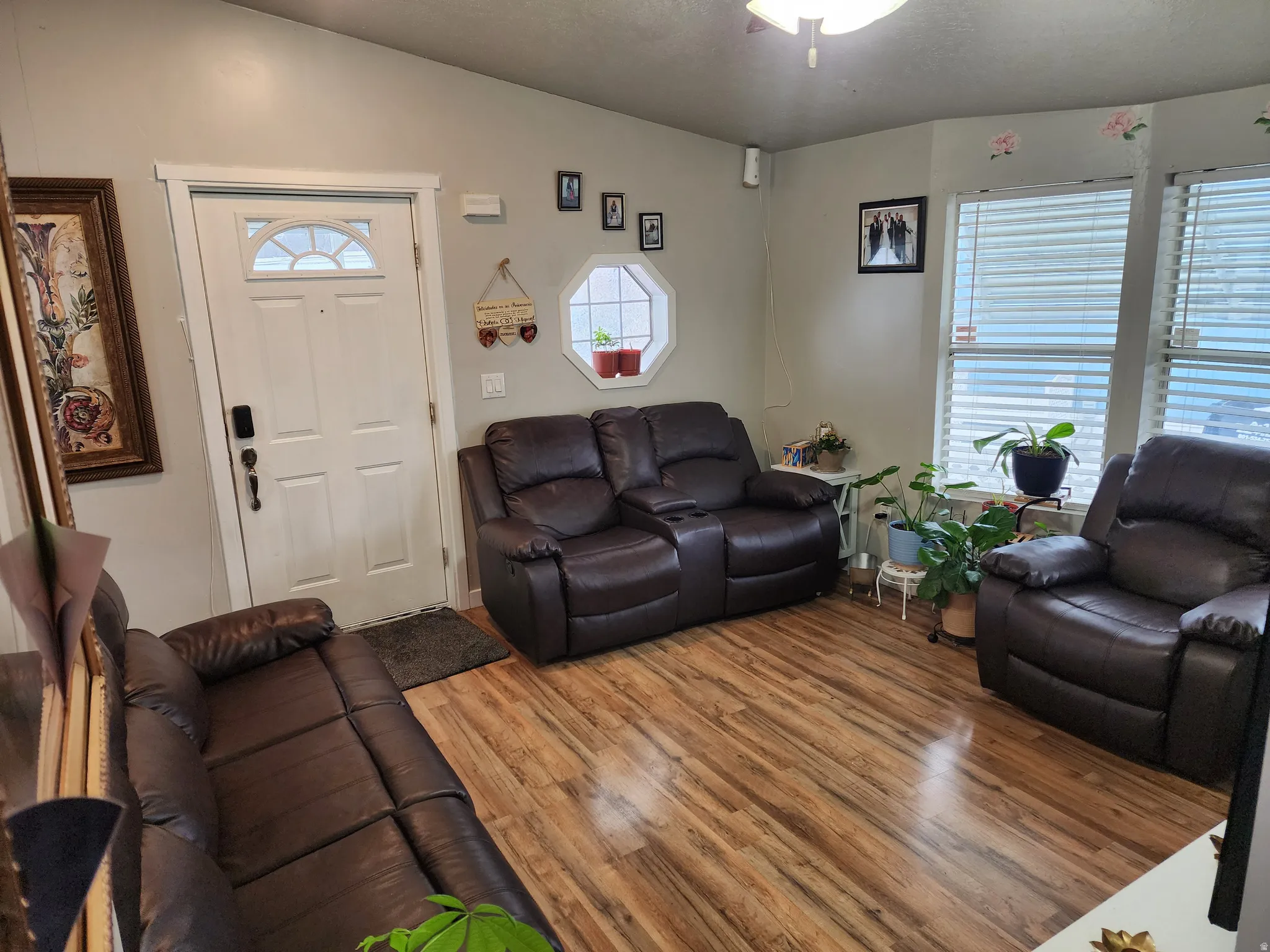 Living area with wood finished floors and lofted ceiling
