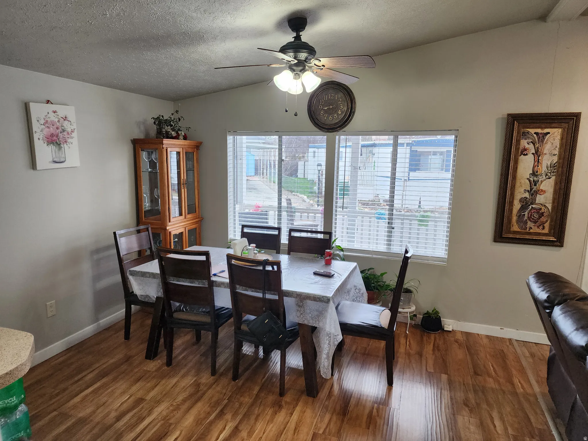 Dining space with ceiling fan and dark wood-style flooring