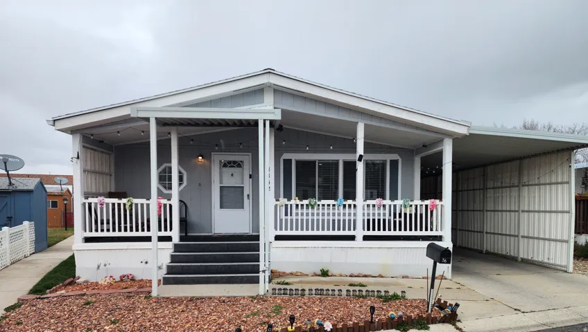 Manufactured / mobile home with covered porch and a carport