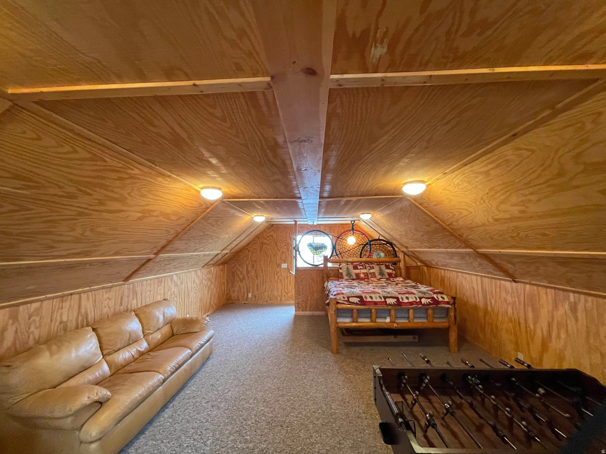 Bedroom featuring wooden walls, carpet flooring, and wooden ceiling