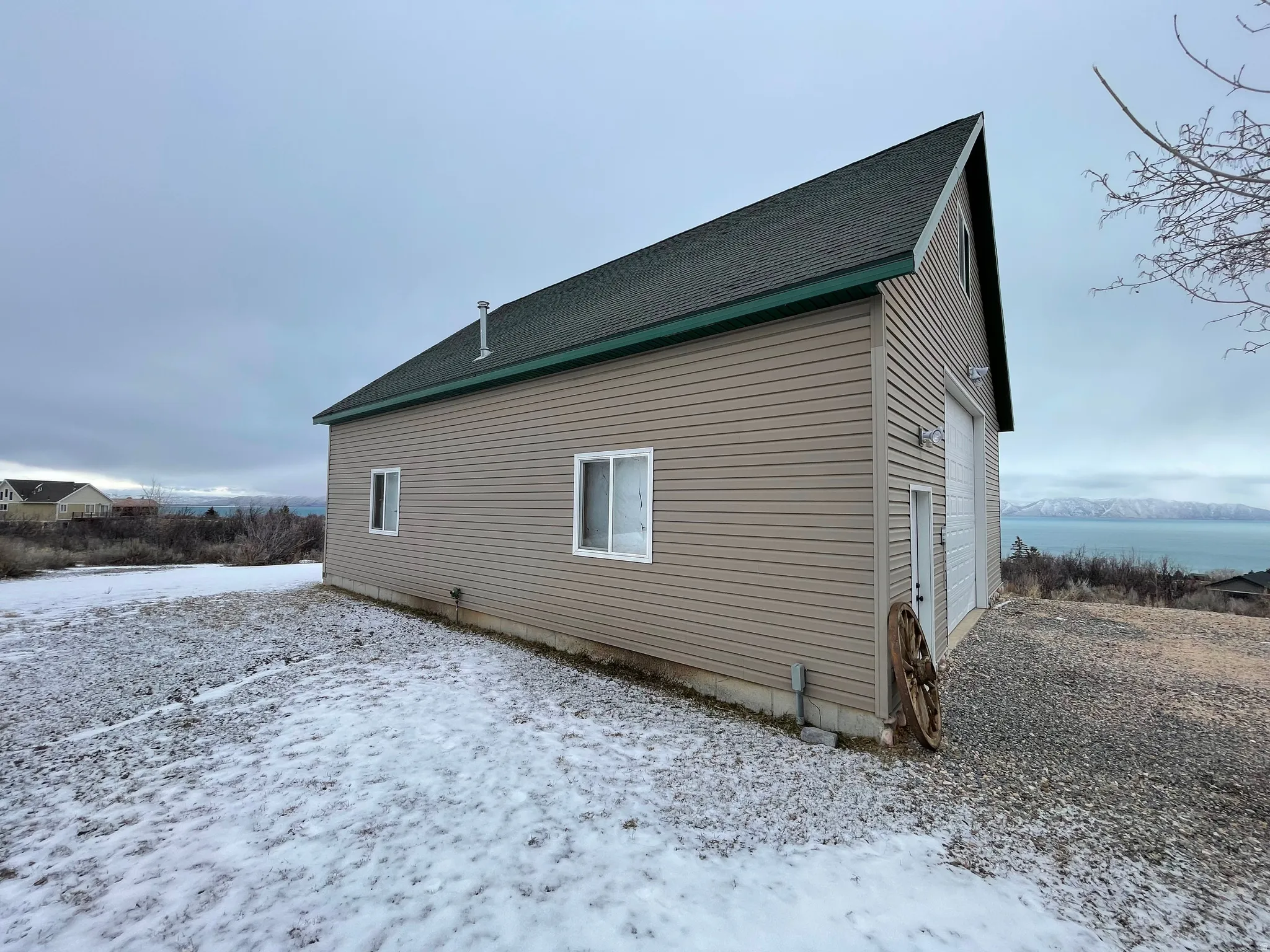 View of side of property featuring roof with shingles