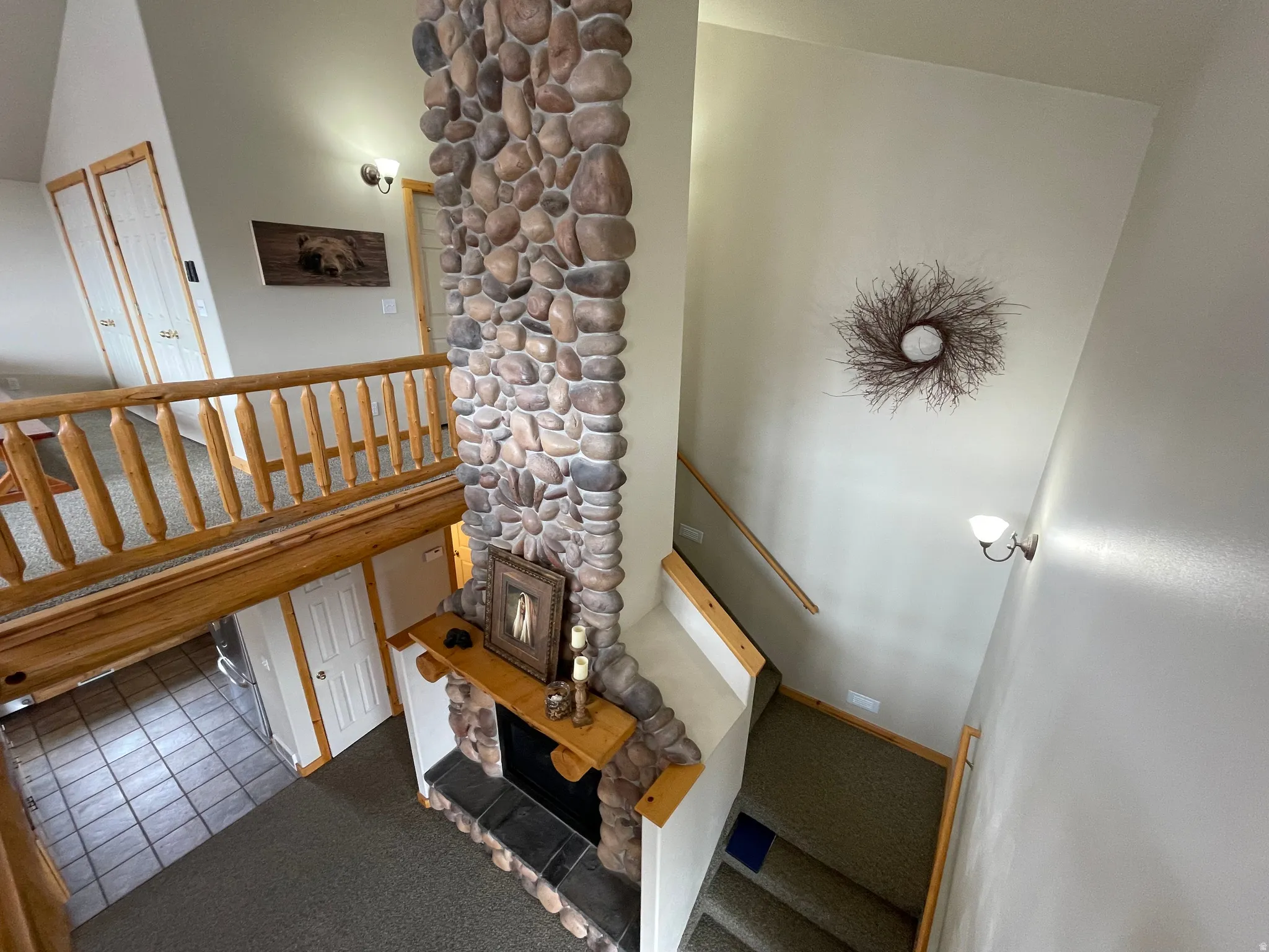 Stairway with a high ceiling, carpet flooring, and tile patterned floors