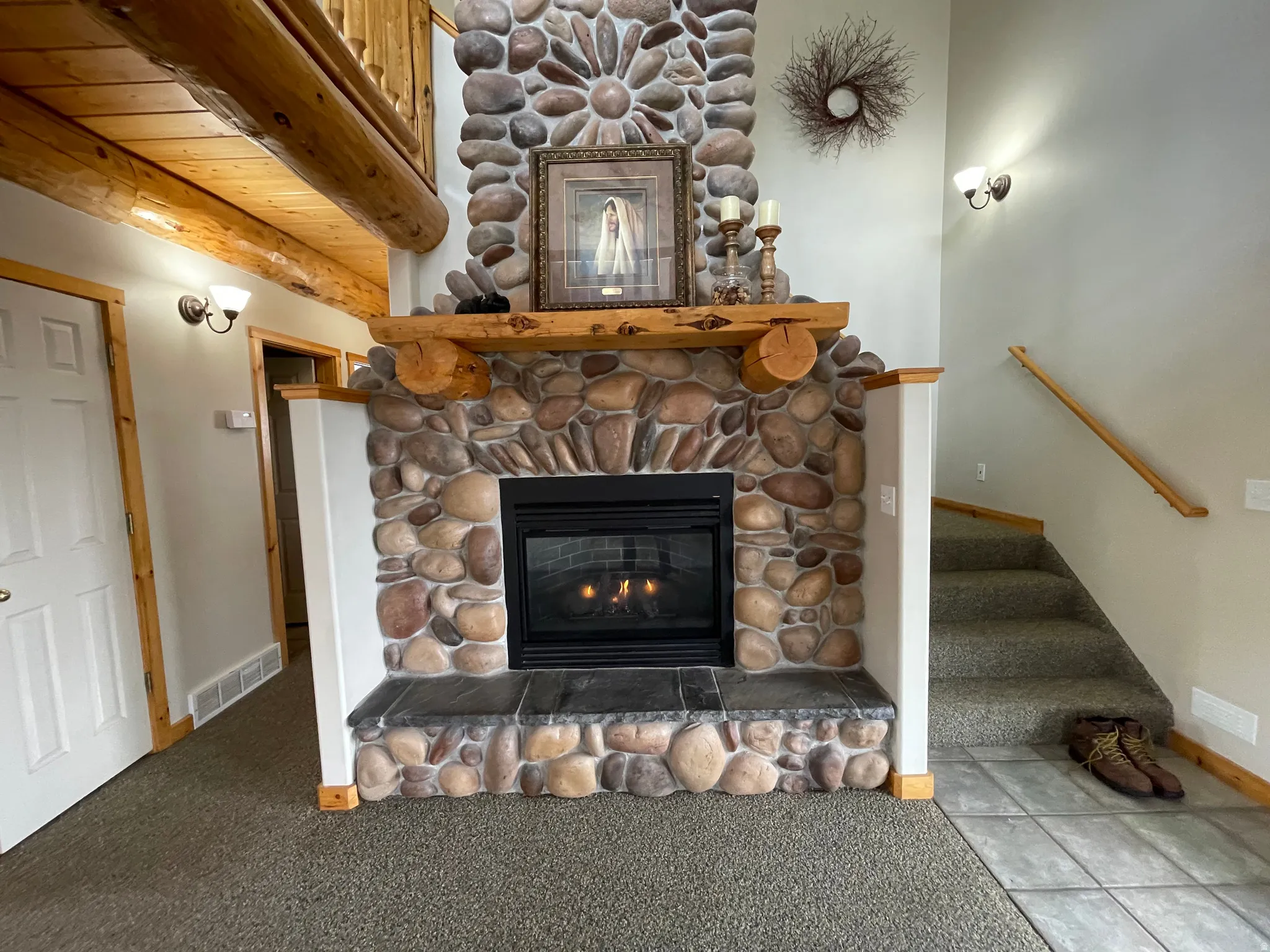 Detailed view of a stone fireplace and carpet