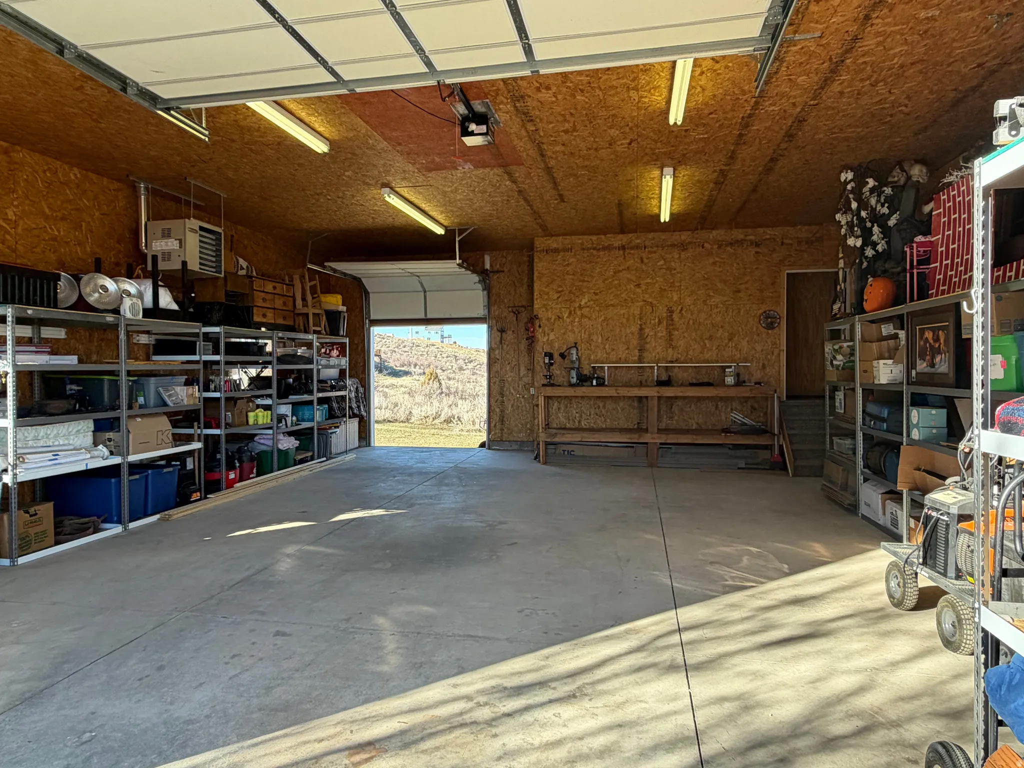 Garage featuring a heating unit and a garage door opener