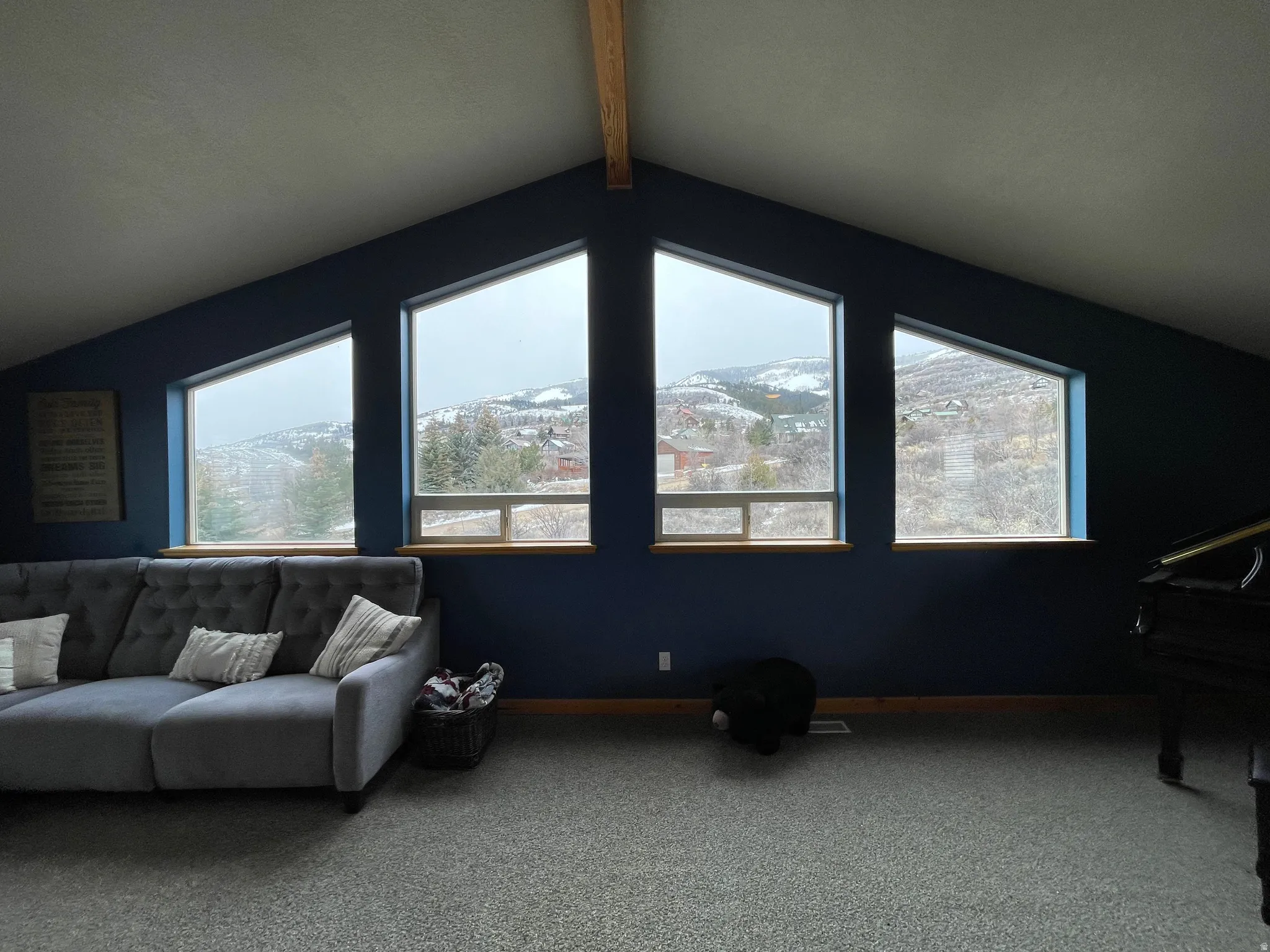 Carpeted living area with beamed ceiling and a mountain view