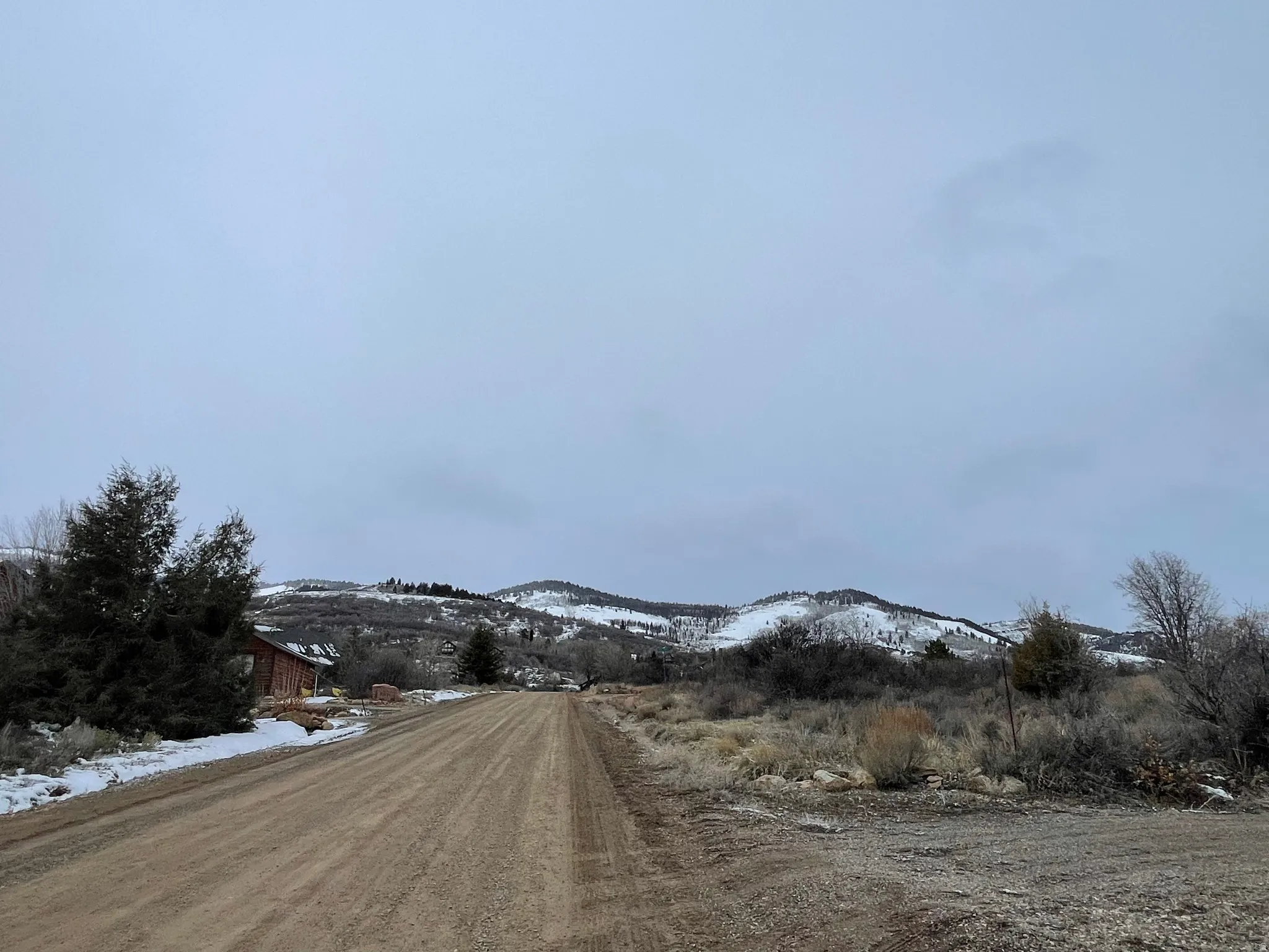 View of dirt / gravel road featuring a mountain view