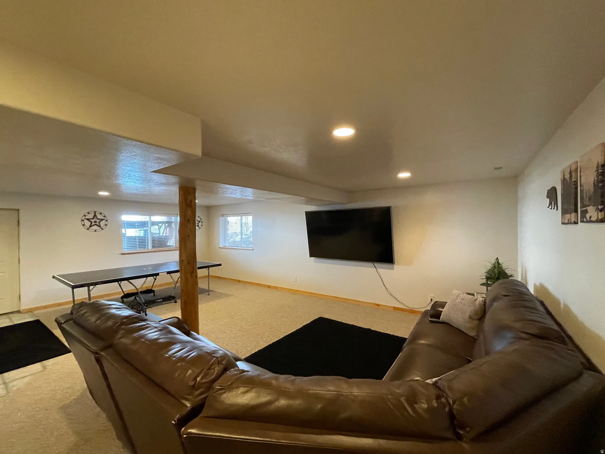 Living room with light carpet and recessed lighting