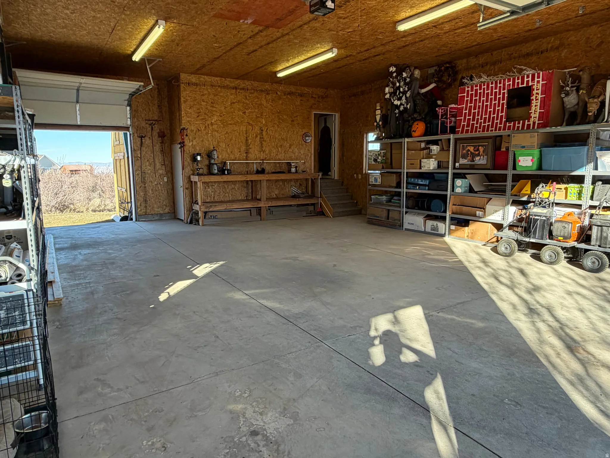 Garage featuring a workshop area and a garage door opener
