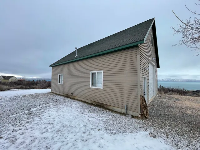 View of side of property featuring roof with shingles