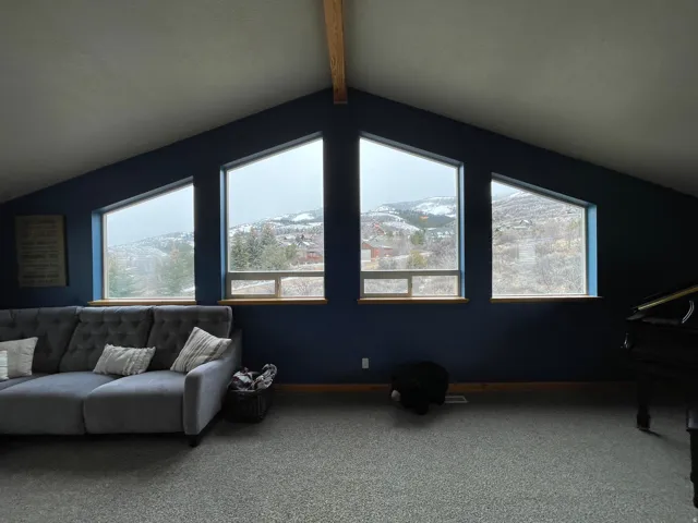 Carpeted living area with beamed ceiling and a mountain view