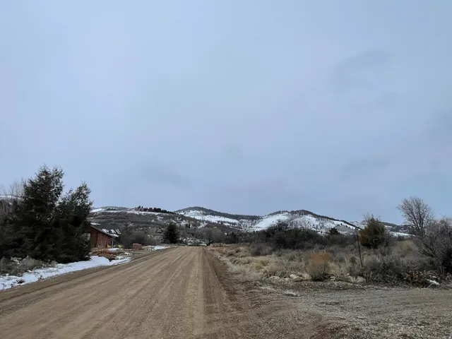 View of dirt / gravel road featuring a mountain view