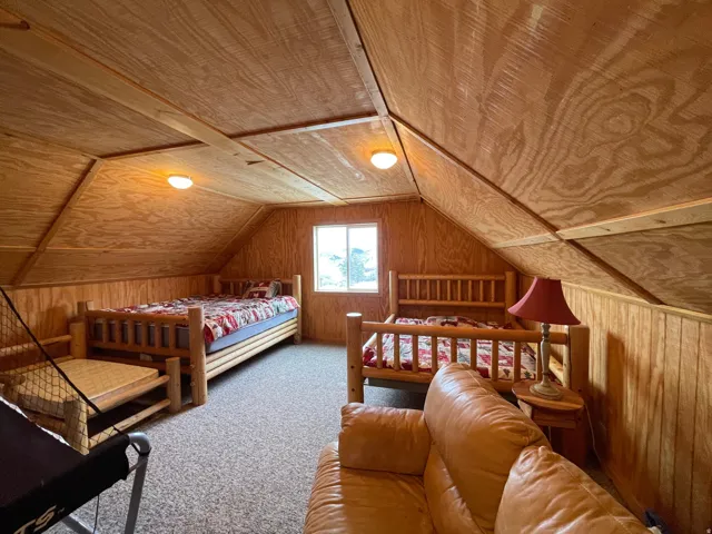 Bedroom featuring wood walls, carpet, and wooden ceiling