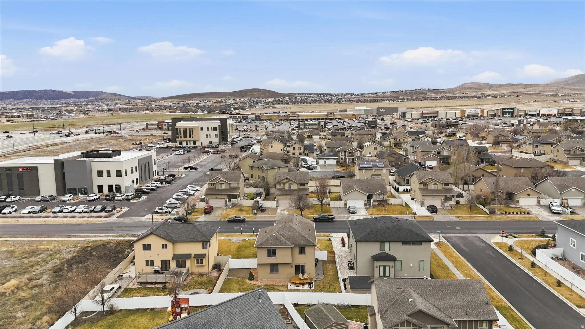 Aerial view of residential area featuring a mountainous background