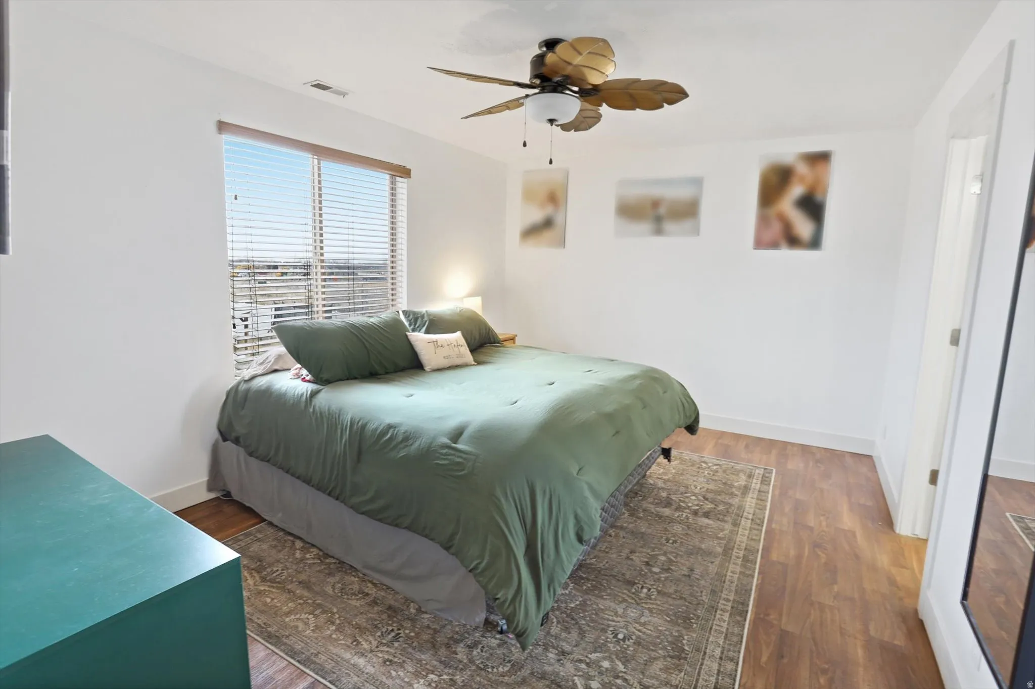 Bedroom with wood finished floors and a ceiling fan