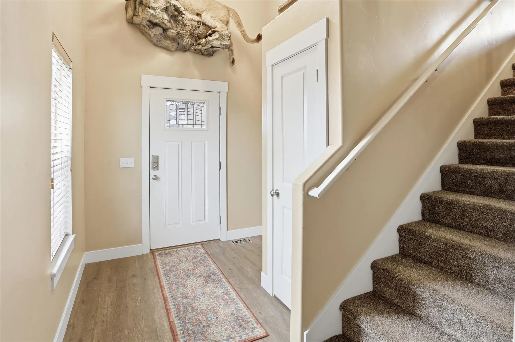 Foyer featuring stairway and light wood-style flooring