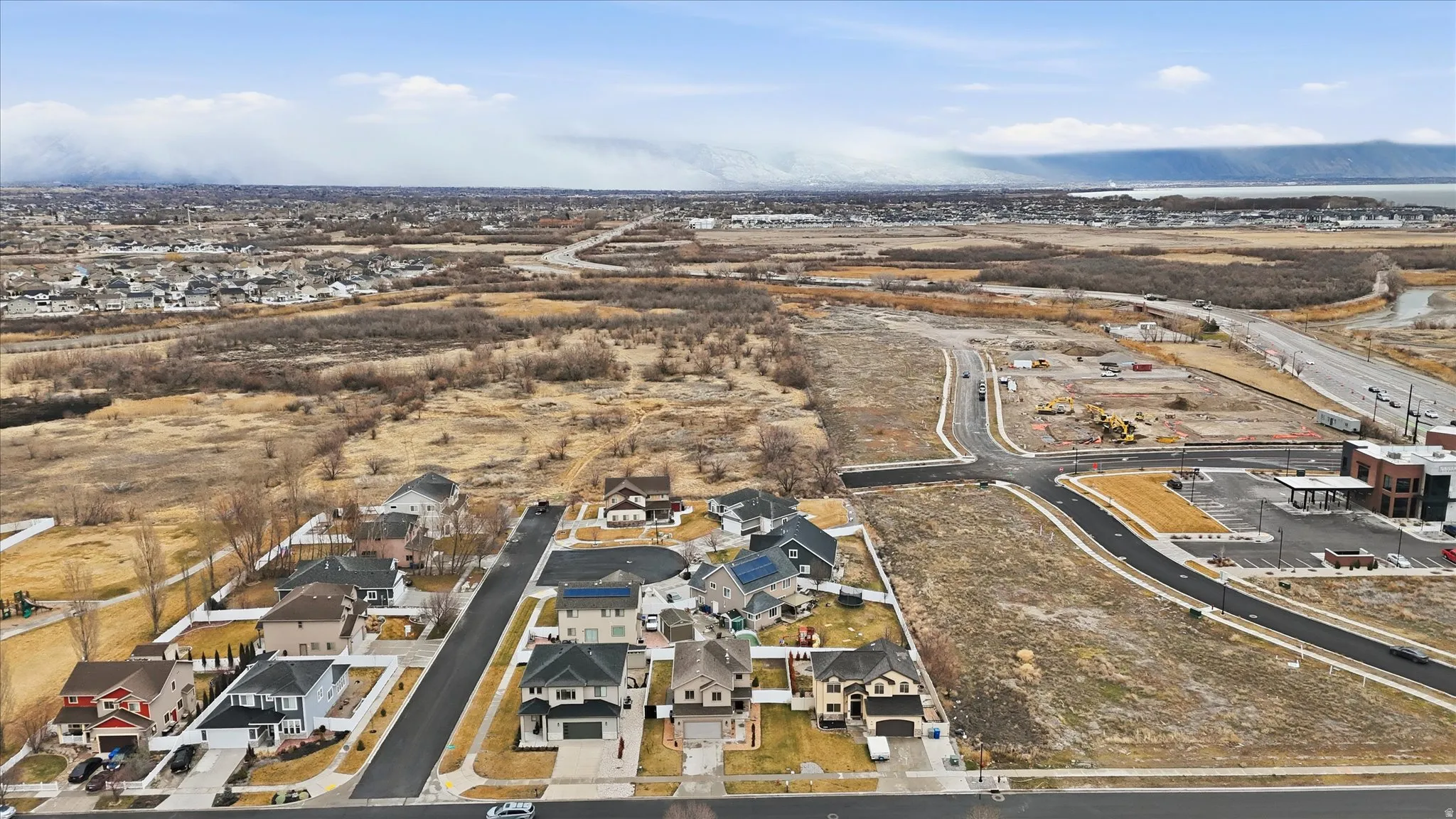 Aerial view of property's location with nearby suburban area