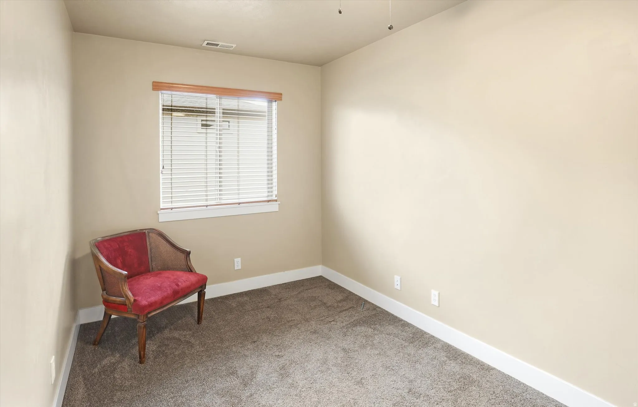 Sitting room with light carpet and baseboards