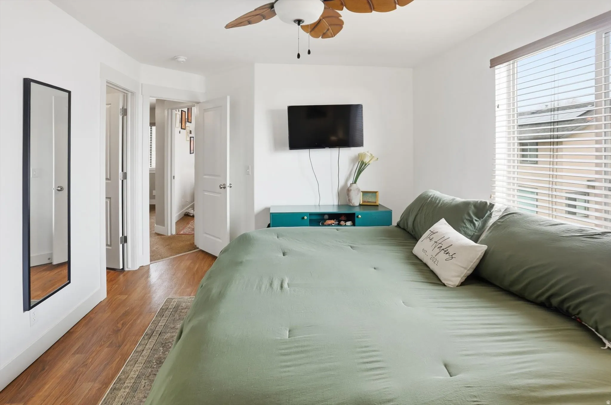 Bedroom with wood finished floors and a ceiling fan