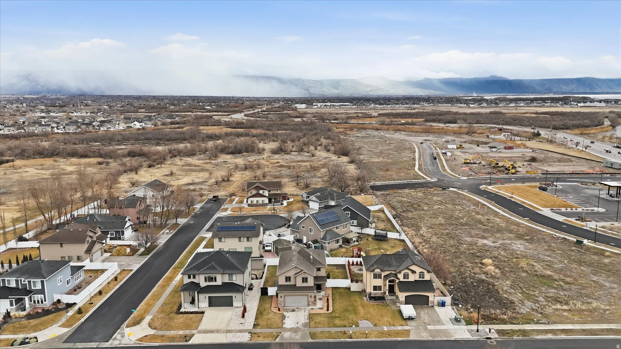 Aerial overview of property's location featuring nearby suburban area and a mountain backdrop