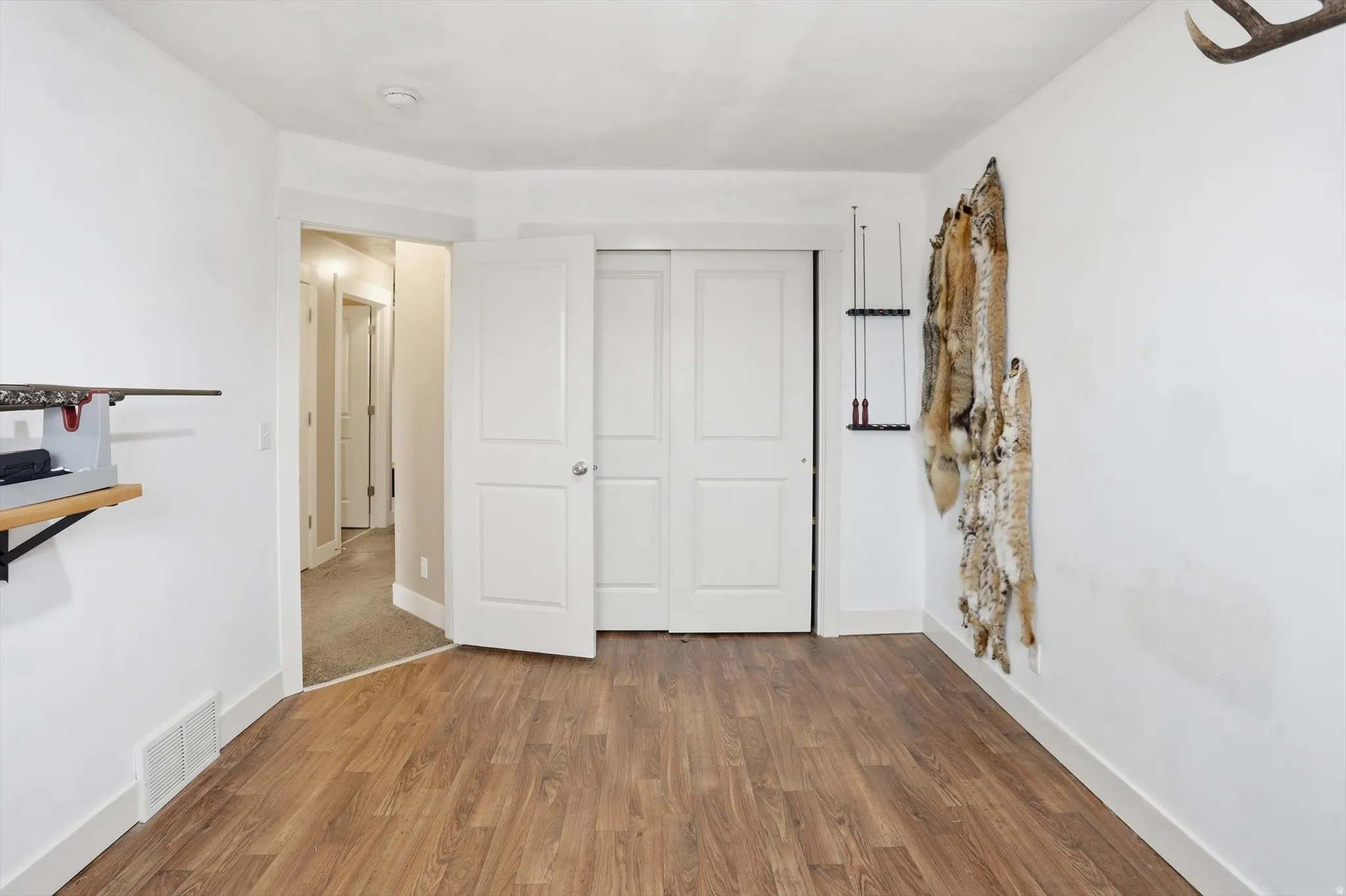 Unfurnished bedroom featuring wood finished floors and a closet
