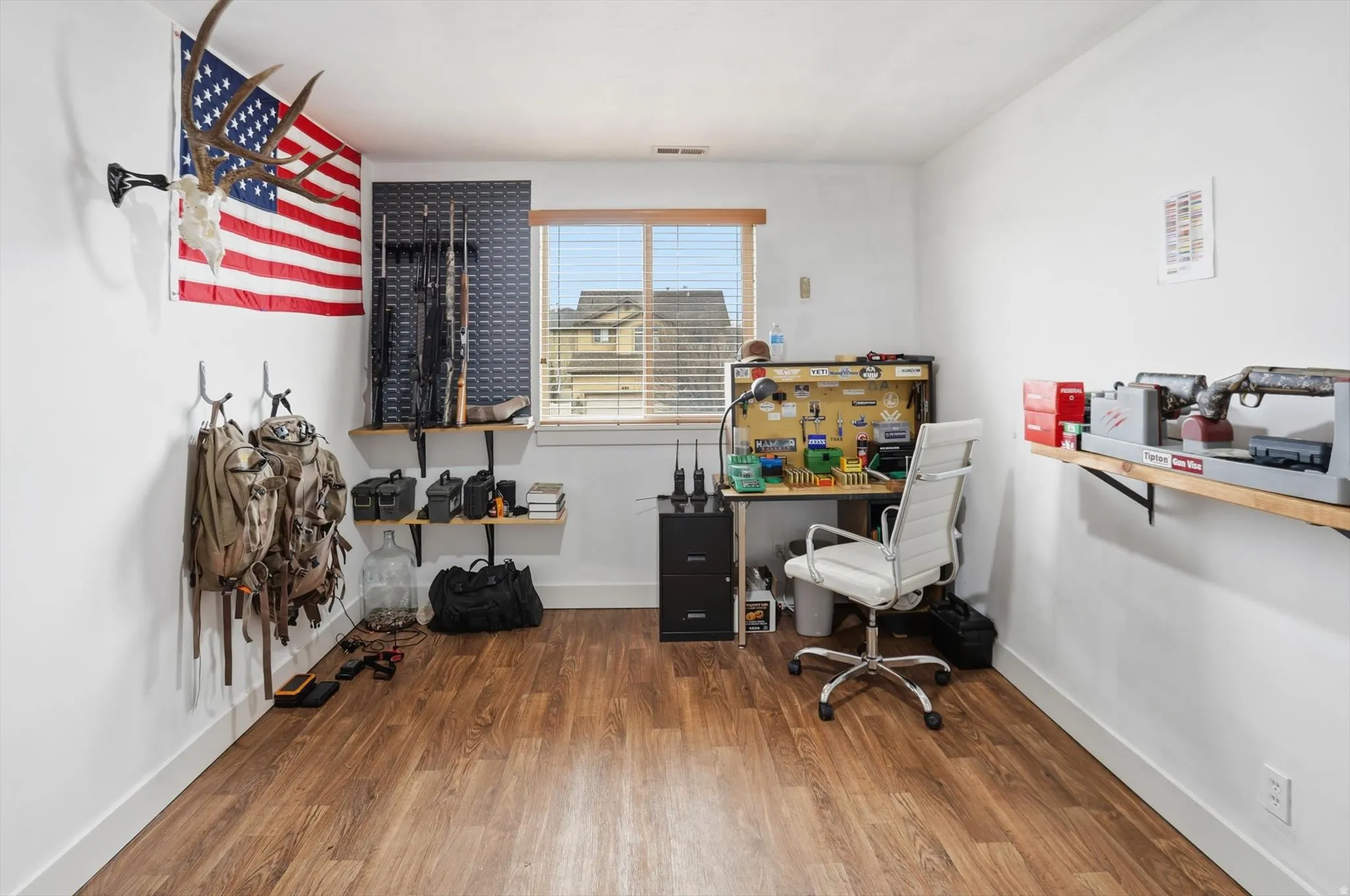 Office area with dark wood-type flooring and baseboards