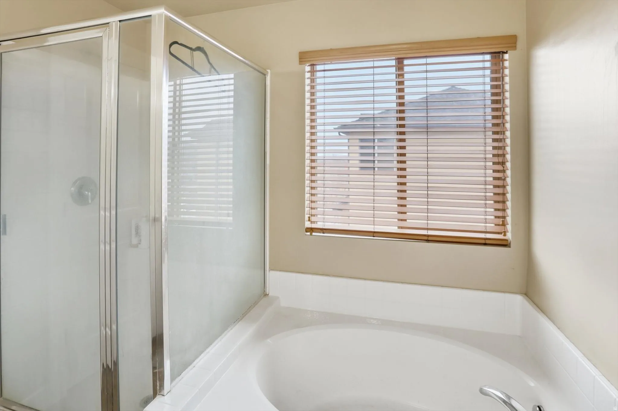 Bathroom featuring a stall shower and a bath