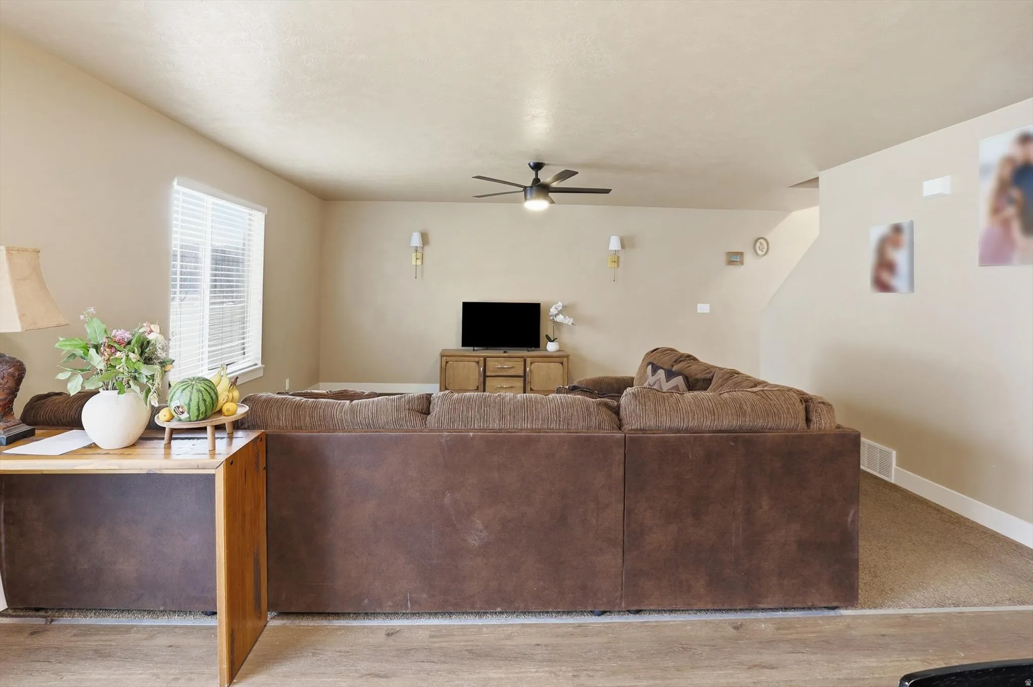 Living room with ceiling fan and baseboards