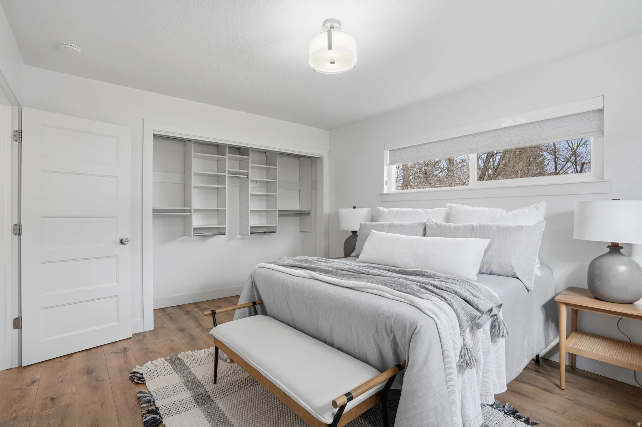 Upstairs Bedroom with light wood-style floors and a closet