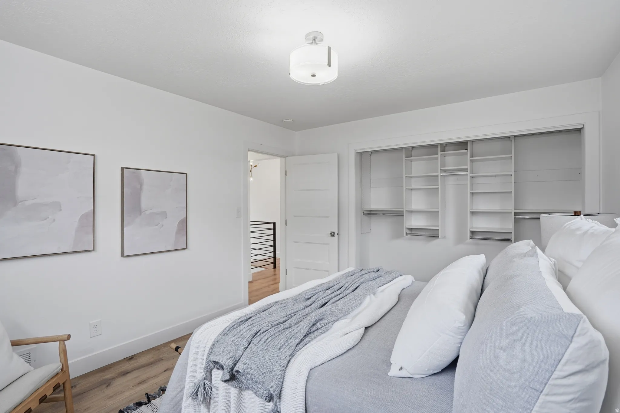upstairs Bedroom with wood finished floors and a closet