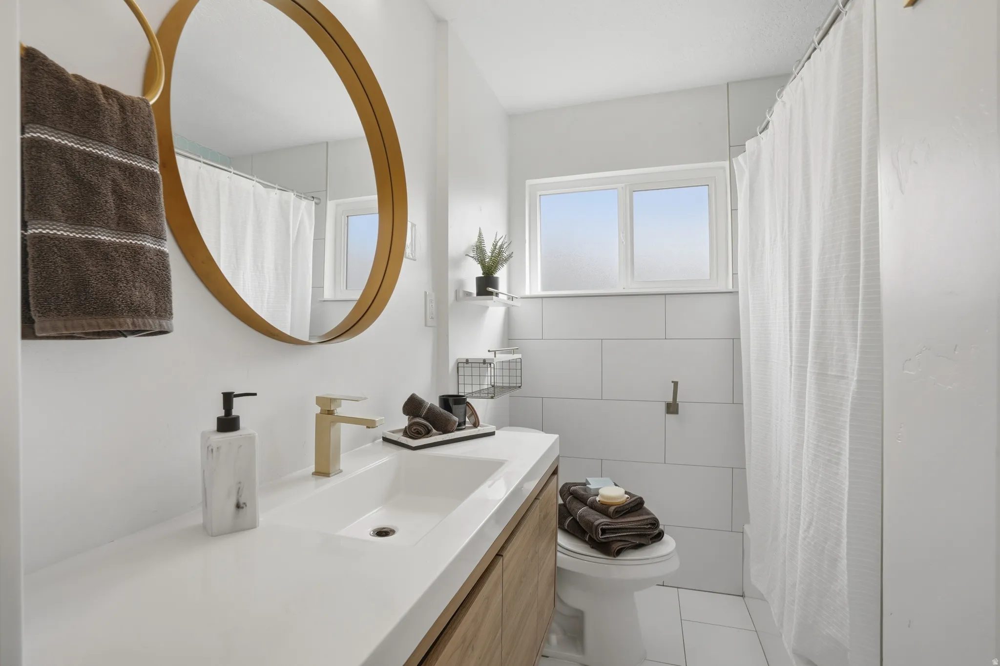 Upstairs Bathroom with vanity, tile walls, curtained shower, and light tile patterned floors