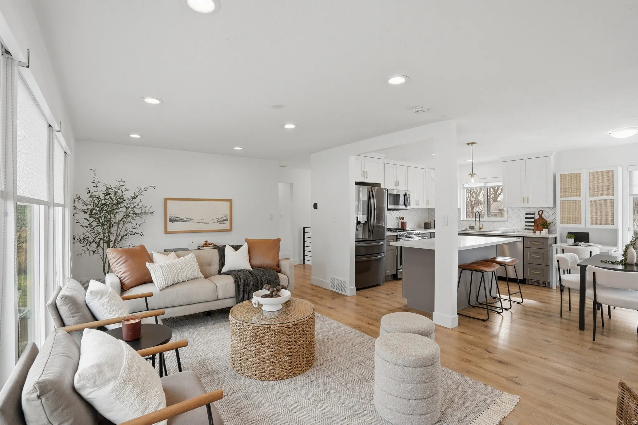 Living area featuring healthy amount of natural light, light wood-style flooring, and recessed lighting