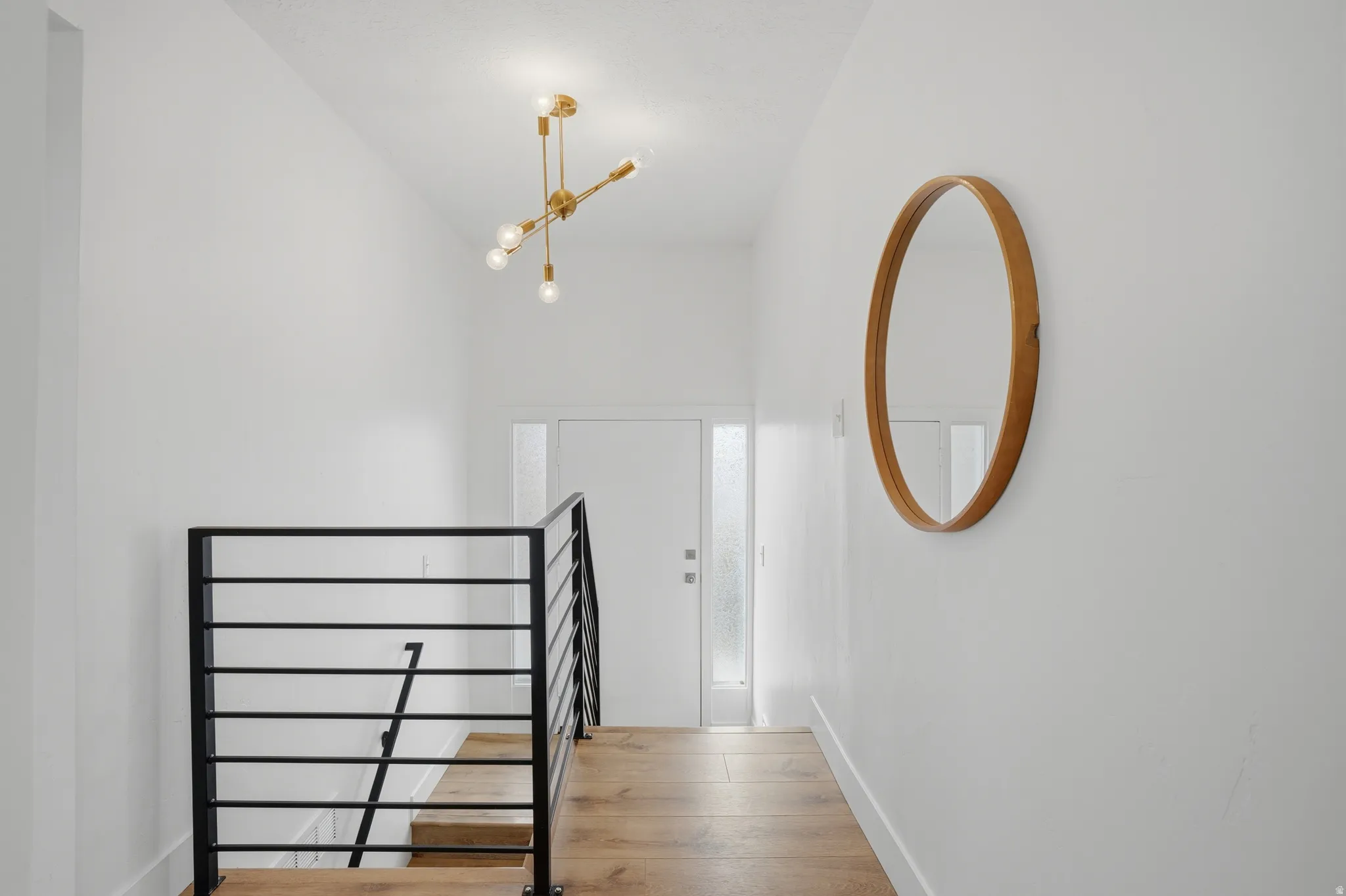 Stairway with baseboards and wood finished floors