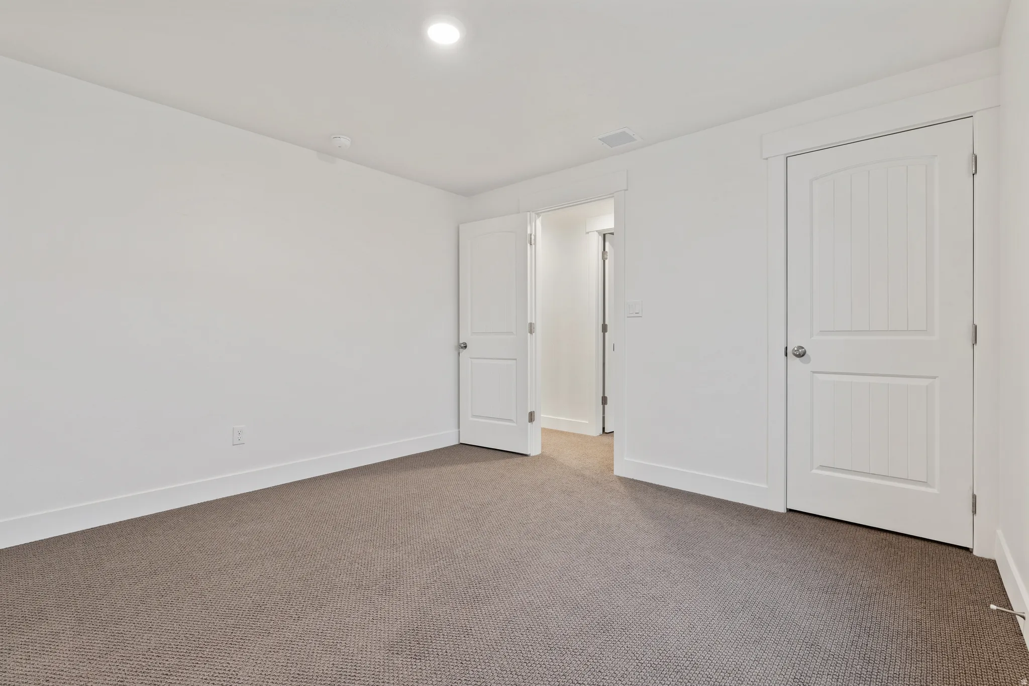 Unfurnished bedroom with carpet and baseboards