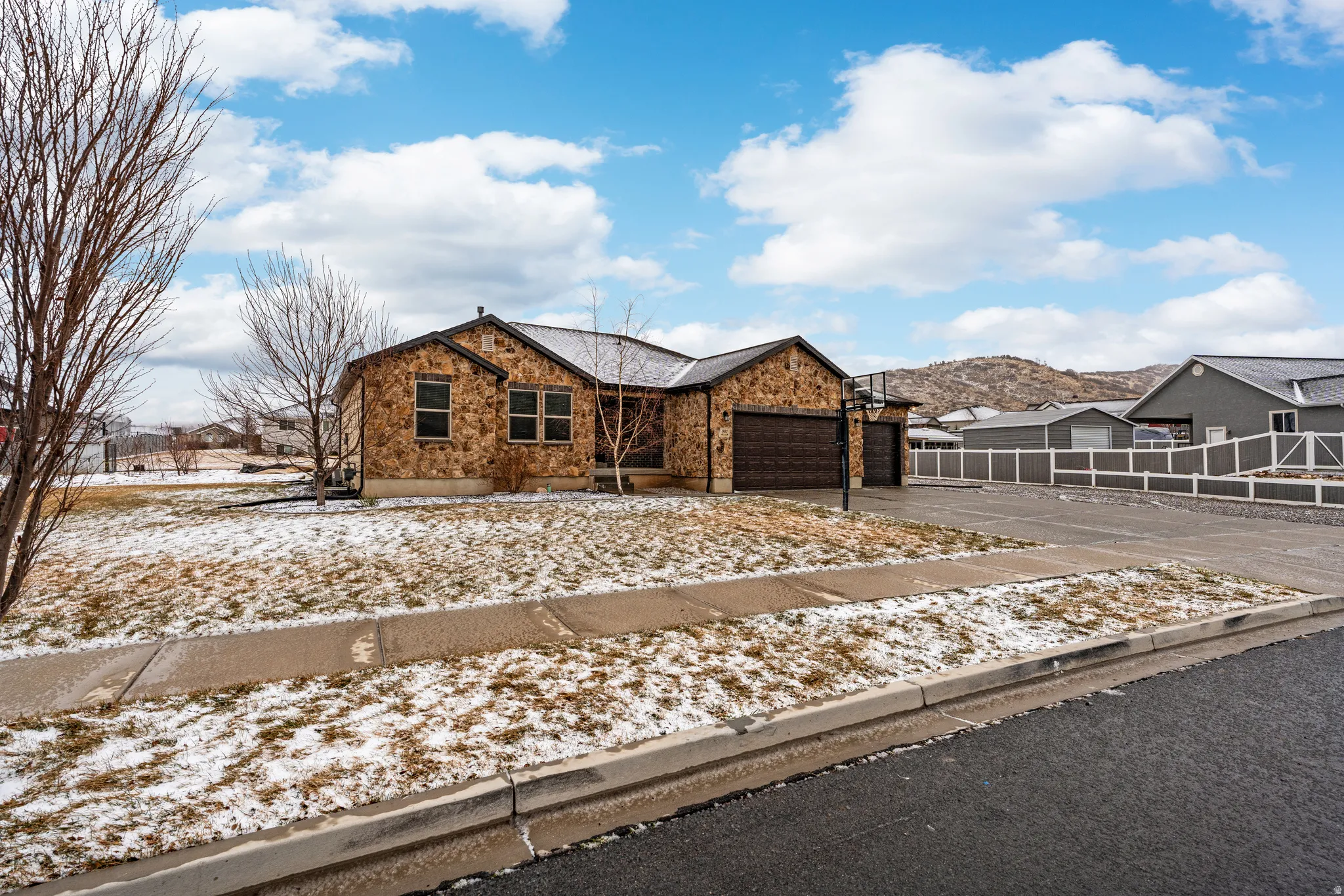 View of front facade with a garage and asphalt driveway