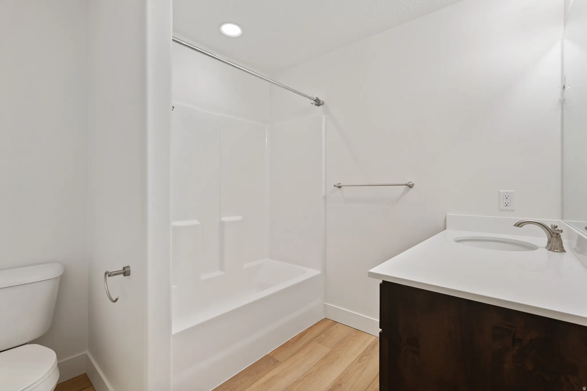 Full bath featuring vanity, light wood finished floors, recessed lighting, and bathtub / shower combination