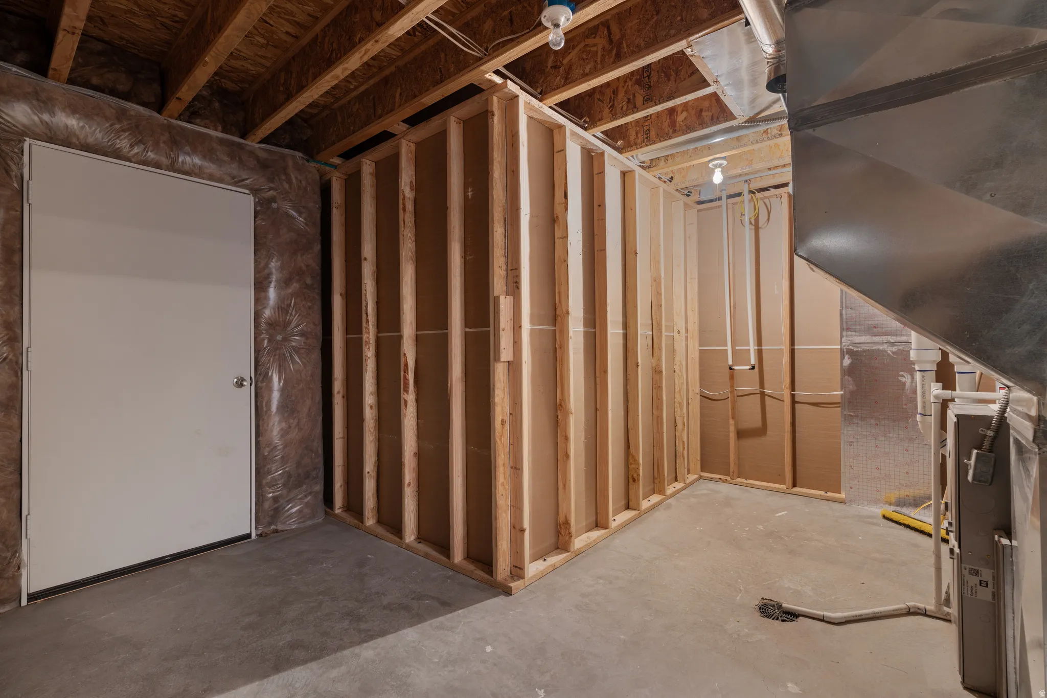 Unfinished below grade area featuring heating unit