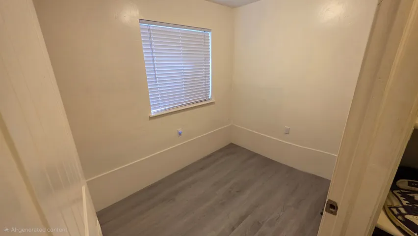 Spare room featuring wood finished floors and baseboards