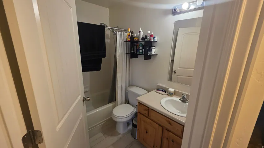 Full bath featuring vanity and shower / bath combo