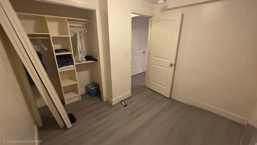 Unfurnished bedroom with dark wood-style flooring and a closet