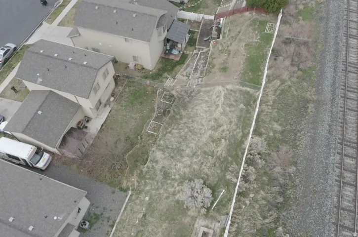 Aerial perspective of suburban area featuring property parcel outlined
