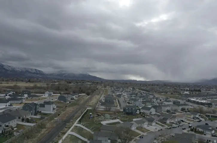Aerial view of residential area featuring a mountain backdrop