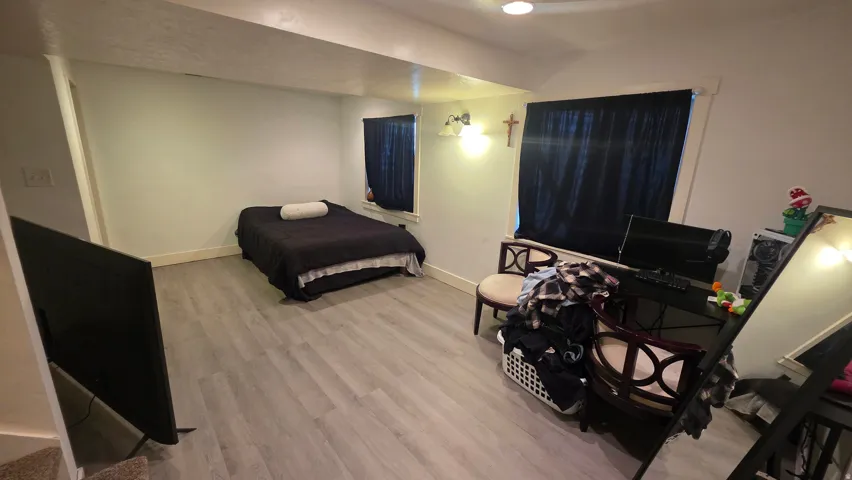 Bedroom featuring light wood-style flooring and baseboards