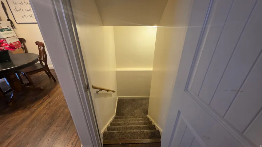 Stairs featuring baseboards and wood finished floors