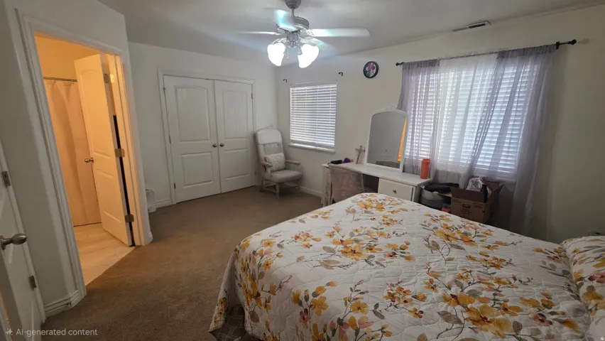 Bedroom with carpet, a ceiling fan, and a closet