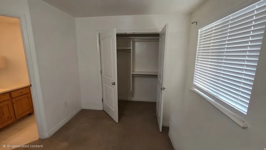 Unfurnished bedroom with a closet and dark colored carpet