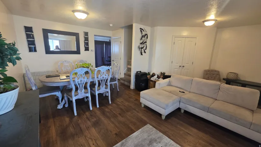 Living area featuring dark wood-style floors and a textured ceiling