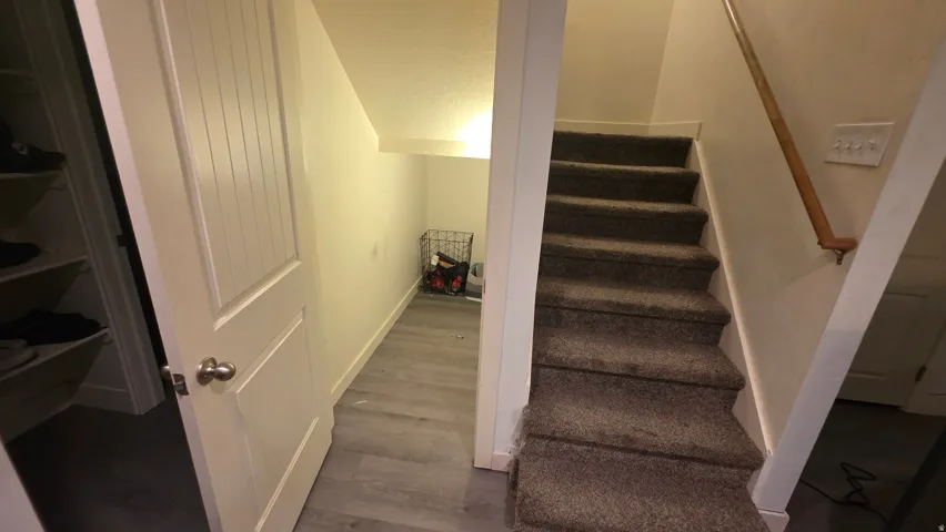 Staircase featuring wood finished floors and baseboards