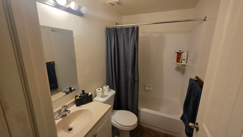 Full bath with vanity and shower / tub combo with curtain