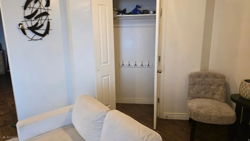 Bedroom featuring dark wood-type flooring and a closet