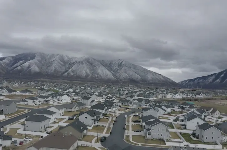 Aerial view of residential area featuring a mountainous background
